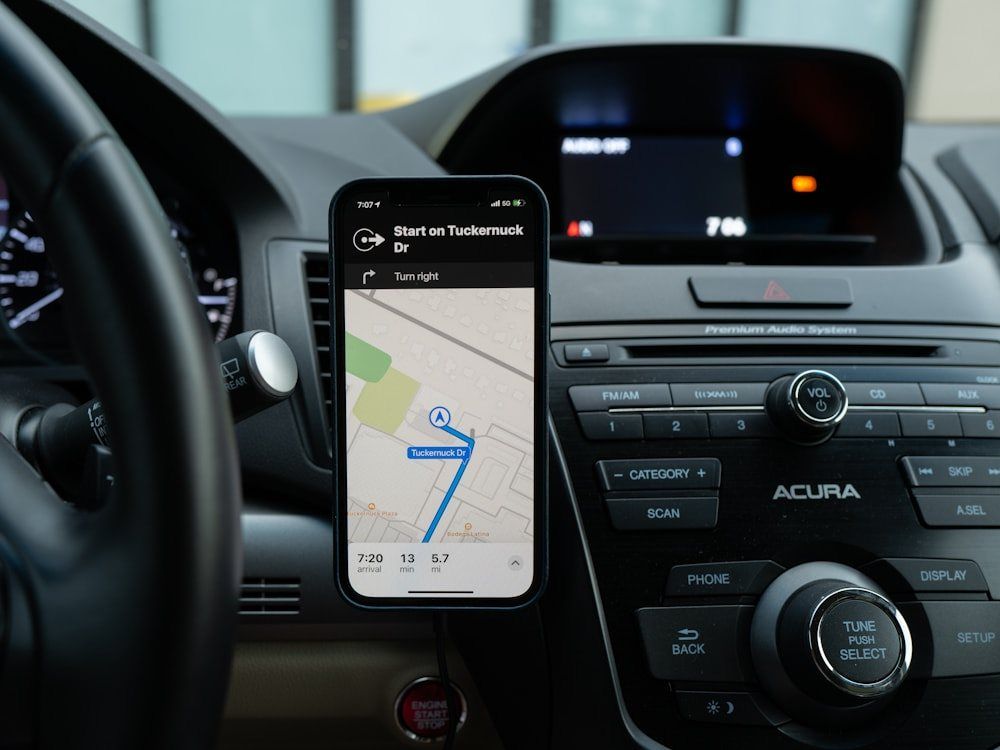 Driver with the Yango app open on a phone mount inside the car